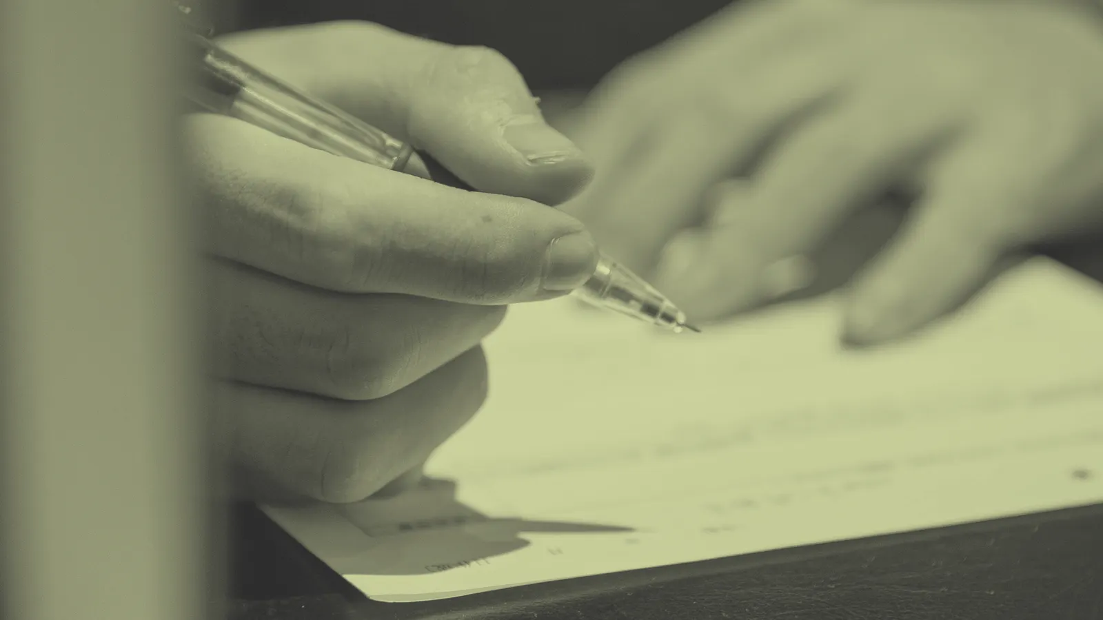 Close-up of a hand editing a printed resume with a pen to tailor it to a job description